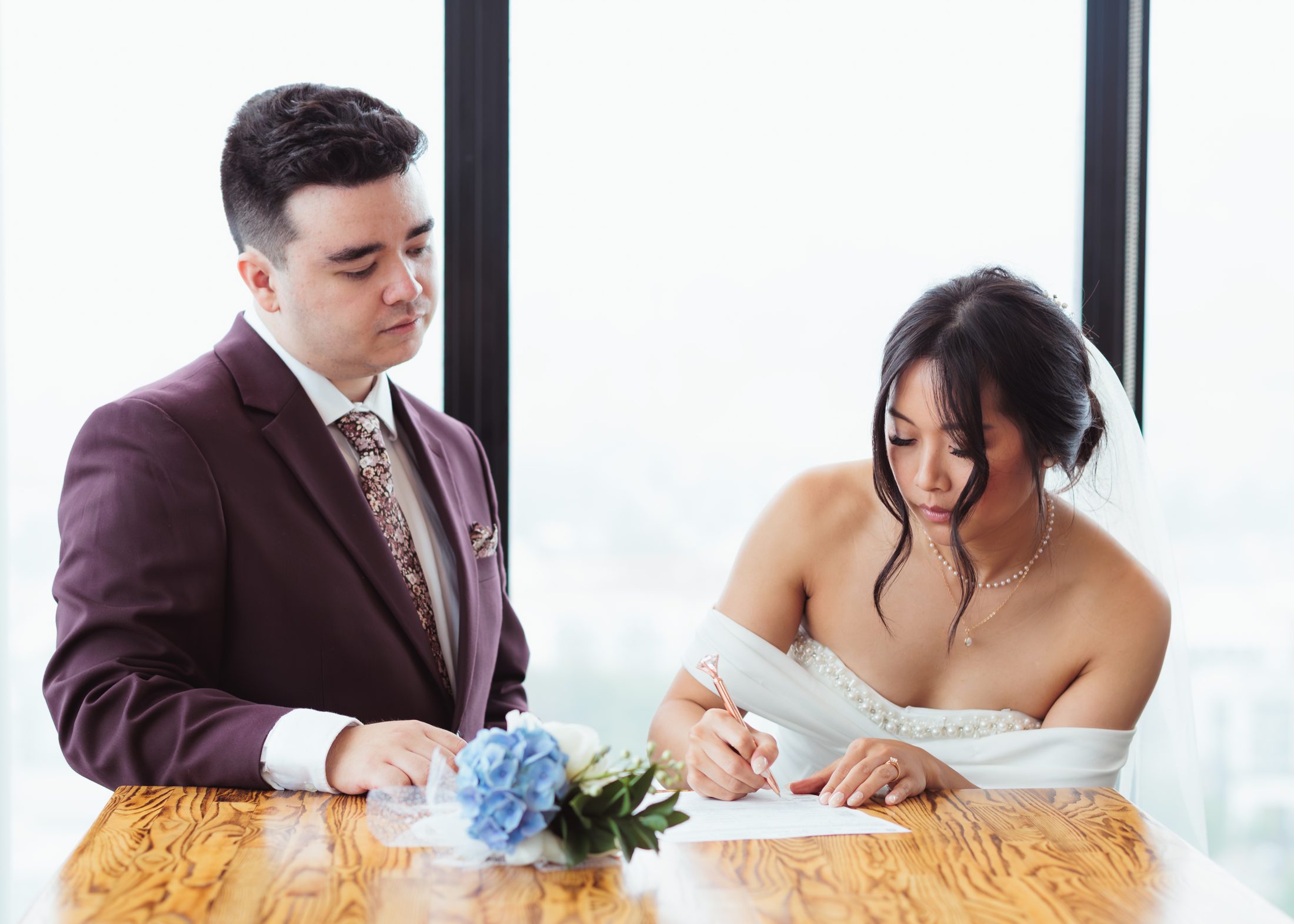 A couple signing their marriage documents together